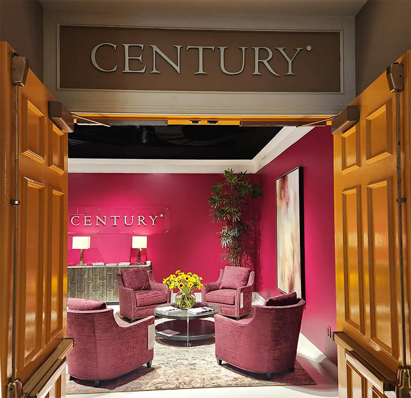 The entrance to the Century Showroom with magenta walls, pink chairs, and gold accents